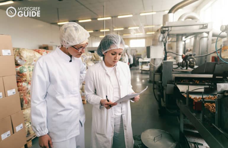 Food Technologist checking quality of food in a factory