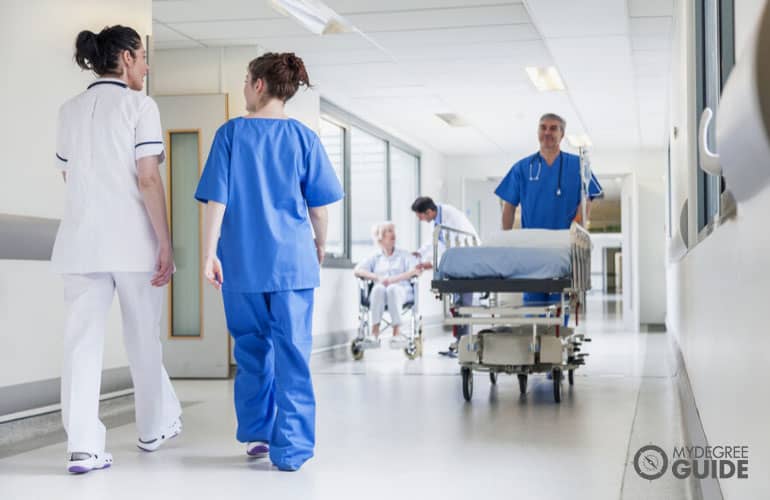 nurses walking in hospital hallway
