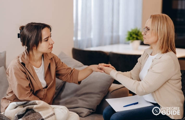psychologist talking to a teenage girl in her office during counseling session