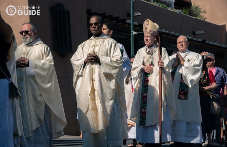 members of clergy walking during a street parade