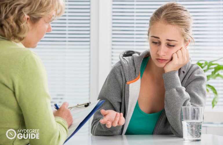 female patient talking to a counselor in her office