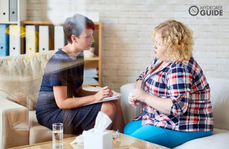 Mental Health Counselor talking to a patient in her office