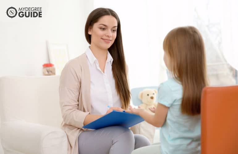 guidance counselor talking to a young girl