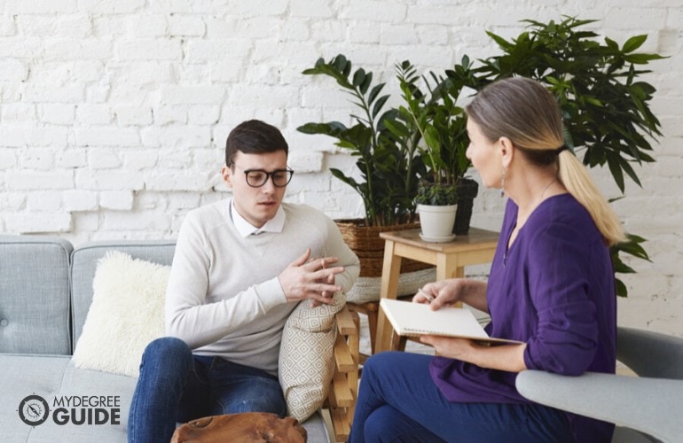 psychologists listening to a client during therapy session