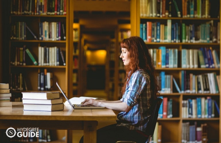 master's degree student studying in university library