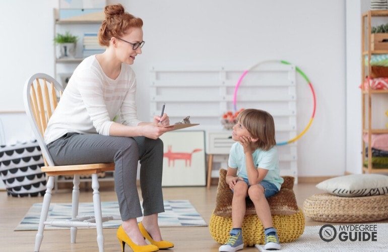 behavioral psychologist talking to an autistic child