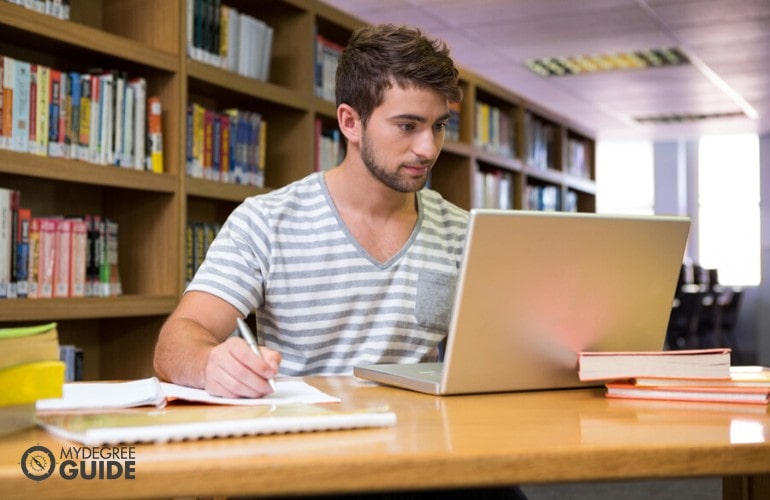 doctorate degree student studying in university library
