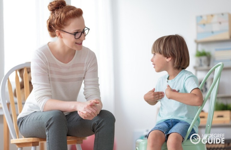 Counselor talking to a child during counseling
