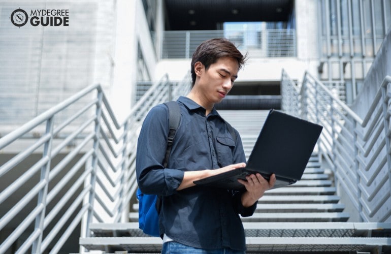Organizational Leadership student with laptop in university campus