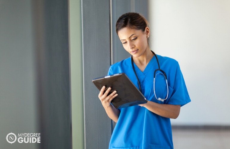 nurse practitioner looking at patient's data on a tablet