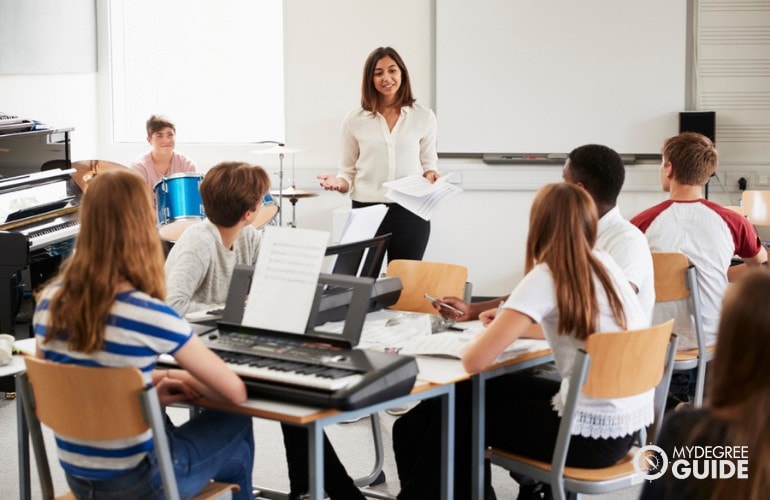 Music Teacher teaching her students in class