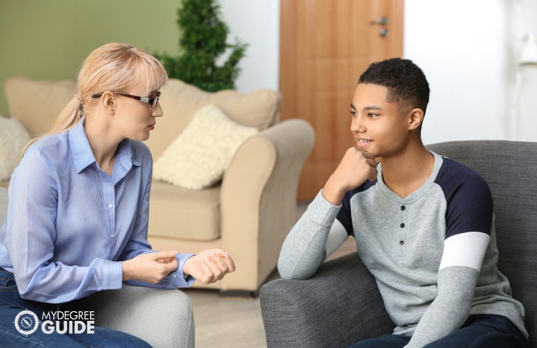 Child Psychologist with a teenage boy during consultation