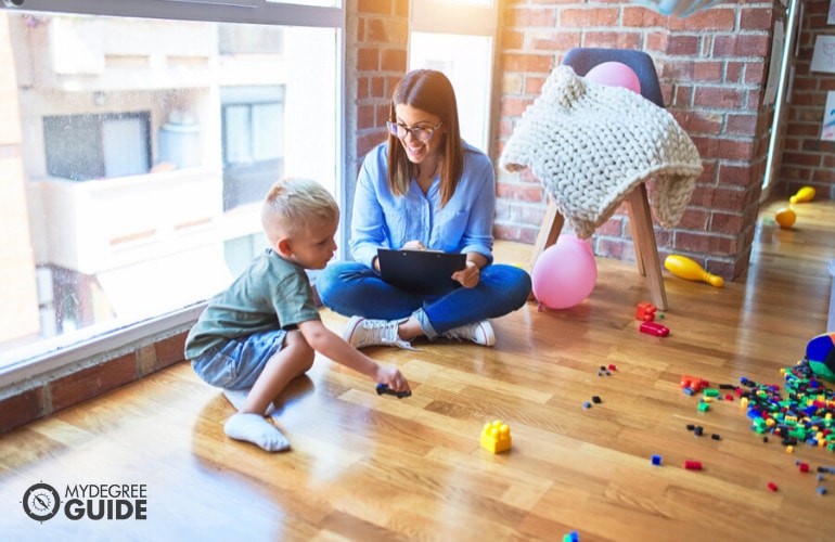 behavioral therapist talking to a child during play therapy session