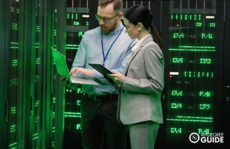 Two Information Research Scientists discussing at data center room