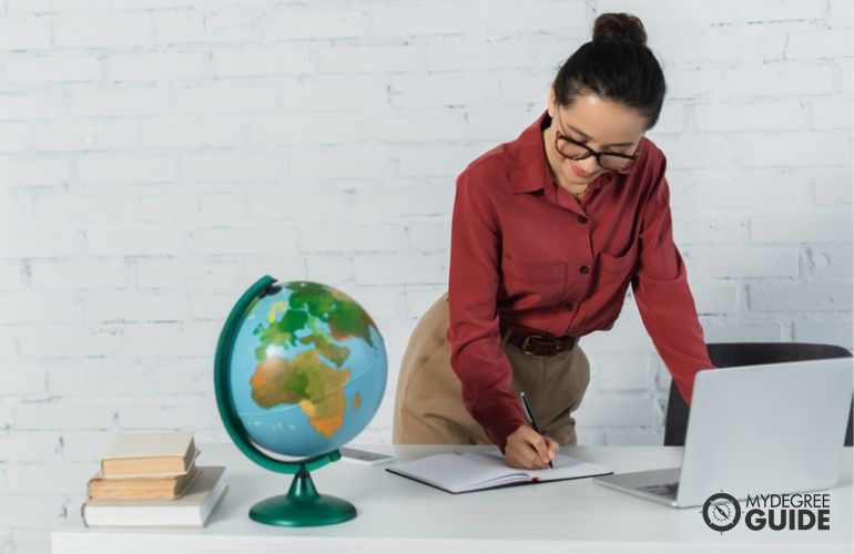 Woman completing her Online Masters in Geography