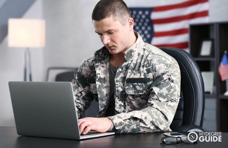 man checking online on best colleges for military veterans