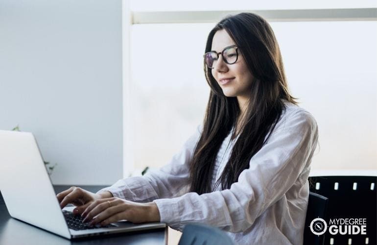 Woman taking Online Business Leadership Degree