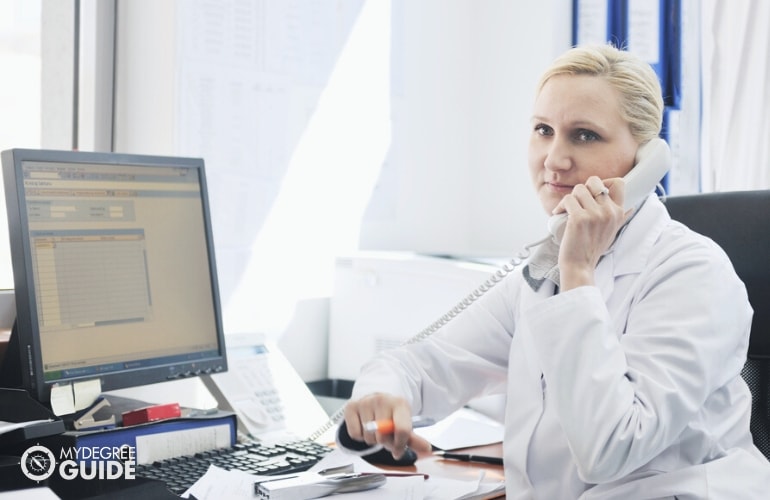 Medical Records Specialist in her office, talking on the phone