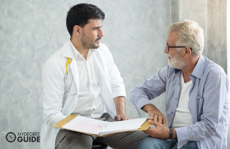 Gerontologist discussing with a patient