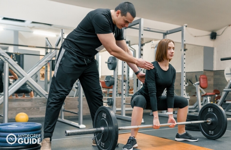 Physical Trainer coaching a woman