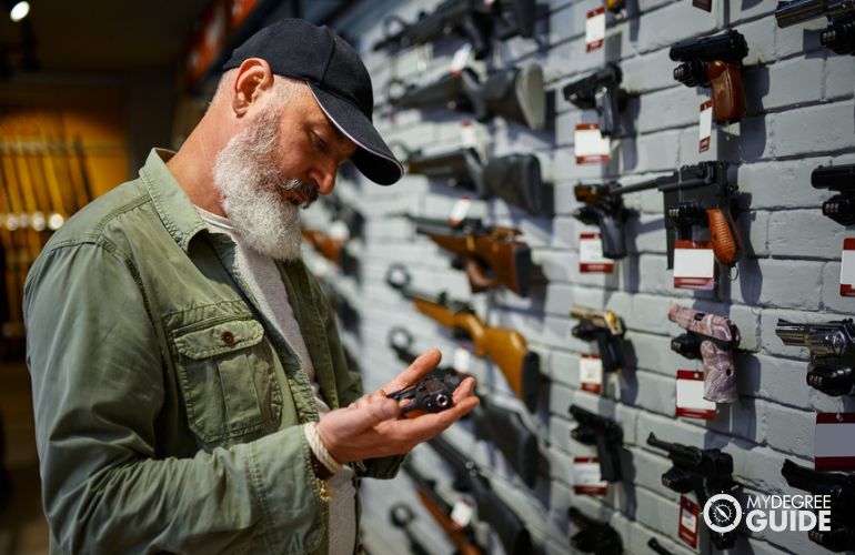 Gunsmith working in a gun store