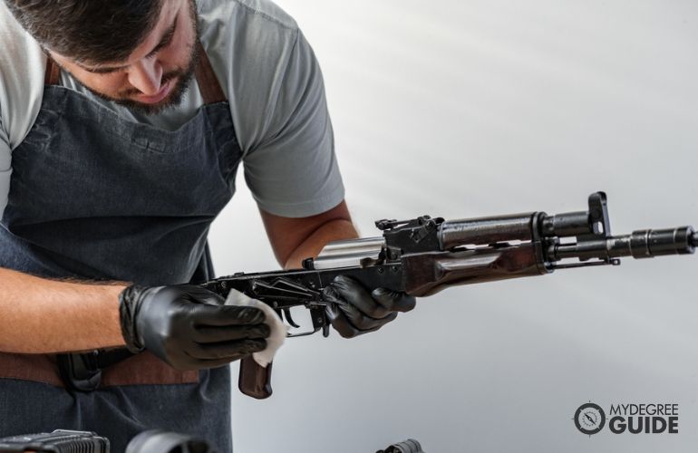 Gunsmith repairing a custom rifle