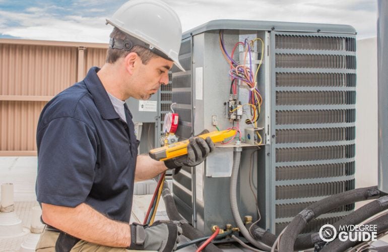 Technician working on commercial HVAC system