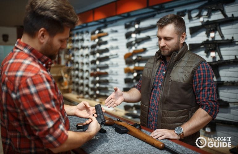 Gunsmith and firearm shop owner having a talk
