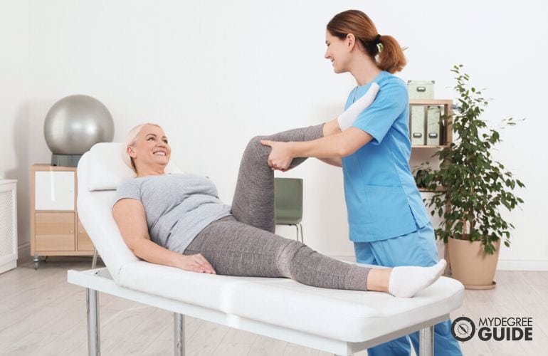 Physical Therapy Assistant helping a patient perform exercises