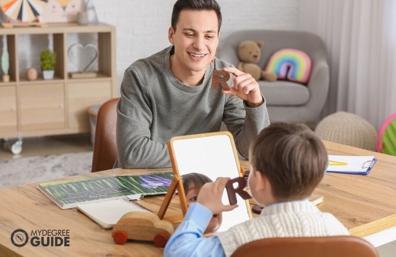 Licensed speech pathologist in a session with a child patient