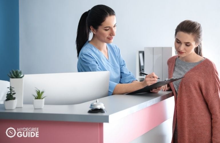 Receptionist in a medical office, confirming patient's appointment