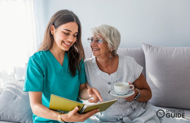 Medical Assistant doing follow up visit with elderly patient