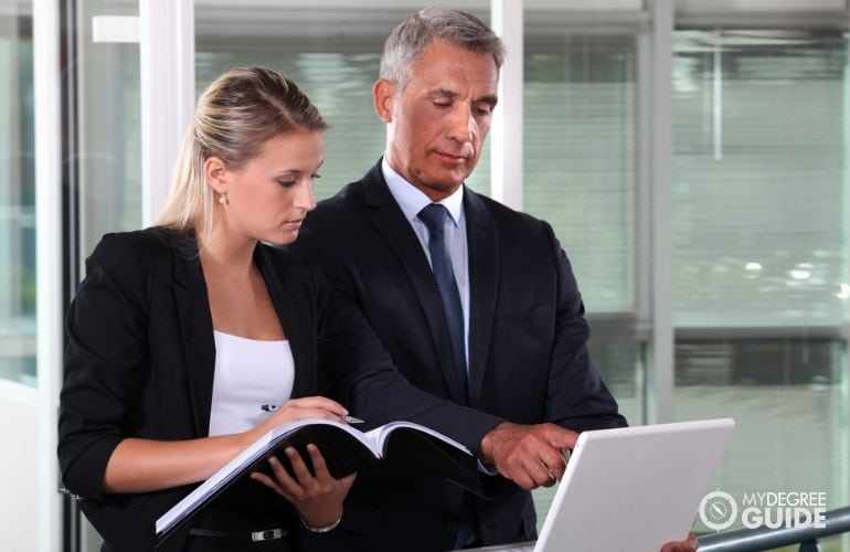 Paralegal taking notes of lawyer's research tasks