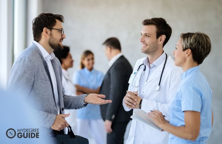 Medical director greeting a doctor and nurse