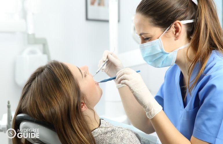Dental Hygienist treating patient's gum disease