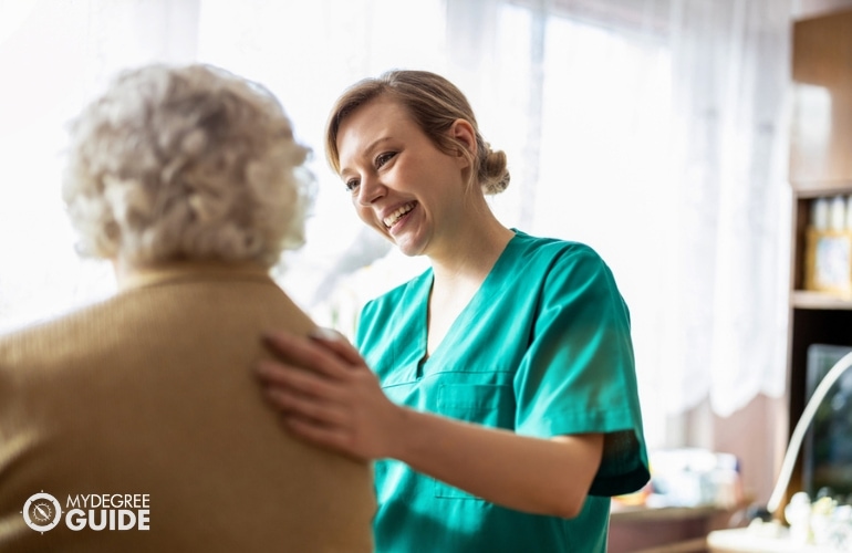nurse comforting an older woman