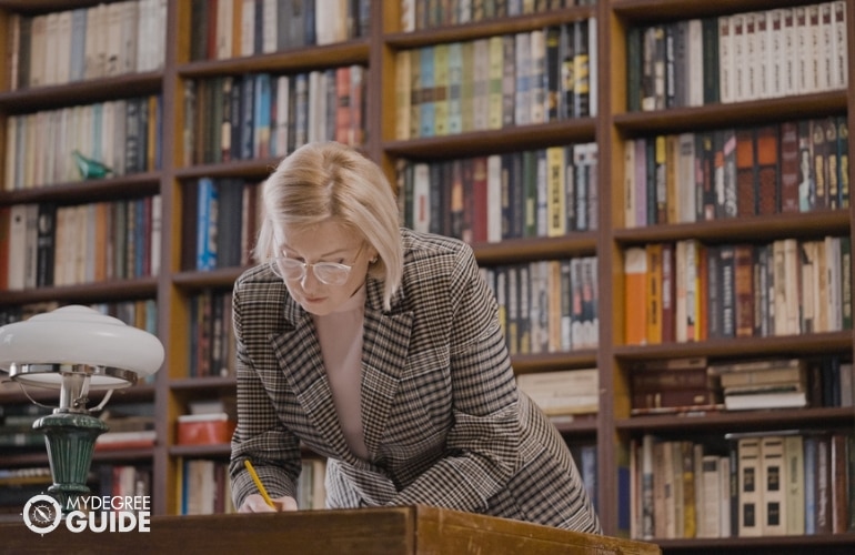 researcher checking archives in a library